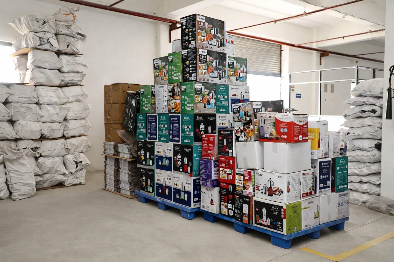 Retail boxes for more than a dozen different appliance brands stacked on pallets at the Topsail factory